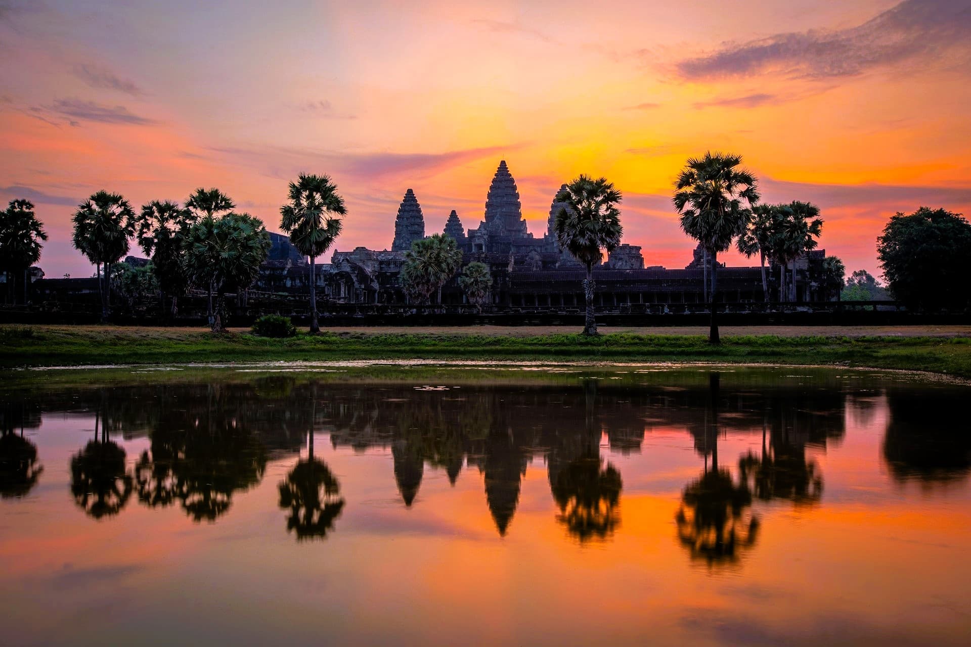 Angkor Wat towers reflected in the pond at sunrise